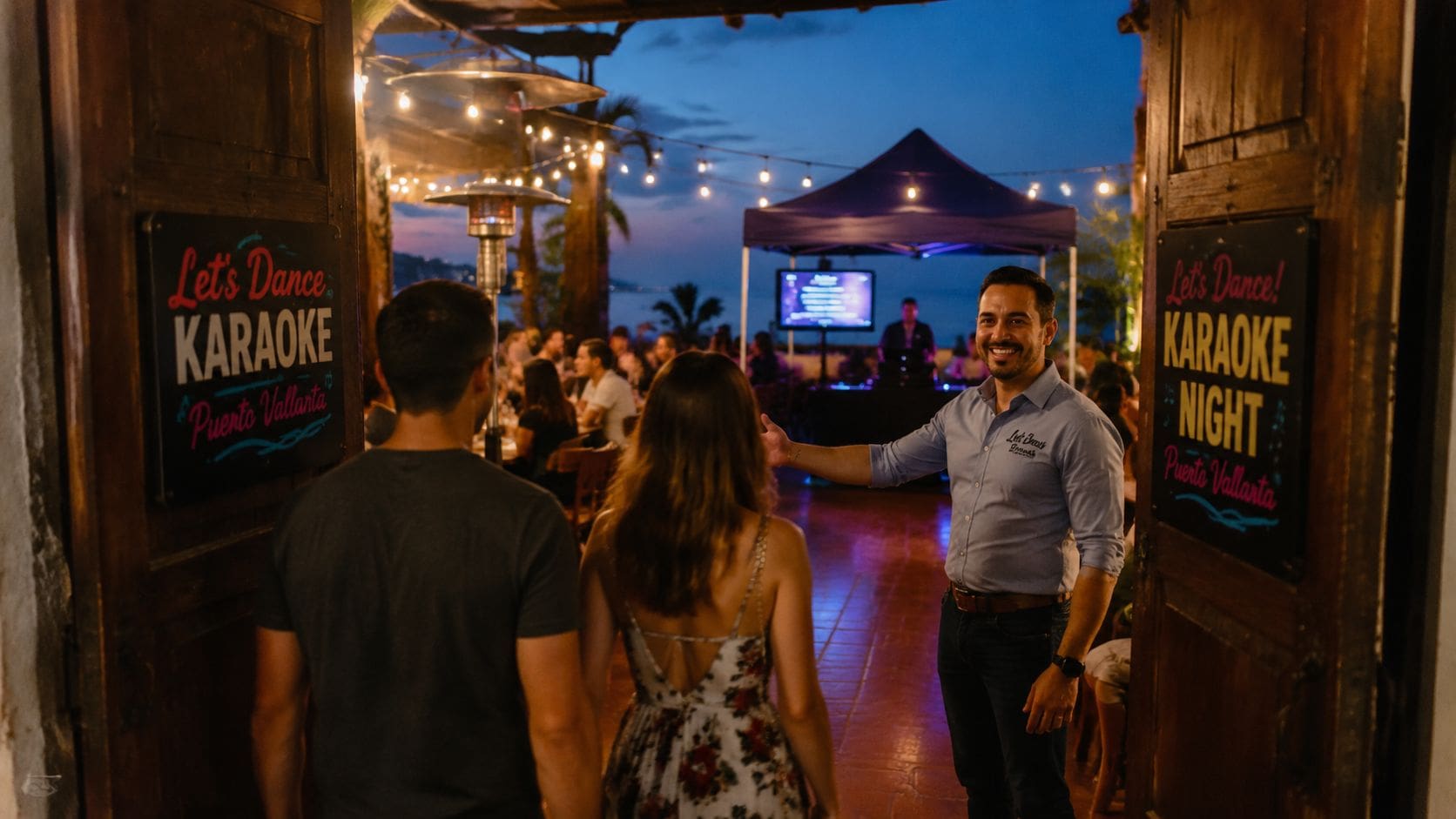 A smiling host welcomes a couple into a scenic outdoor karaoke venue in Puerto Vallarta at dusk.
